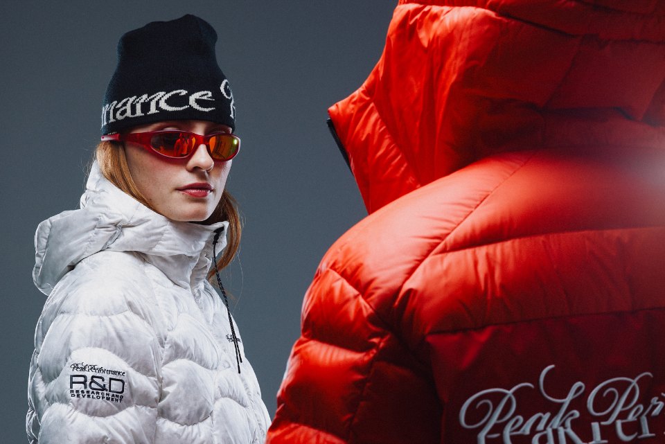 Model in a white Peak Performance R&D down jacket